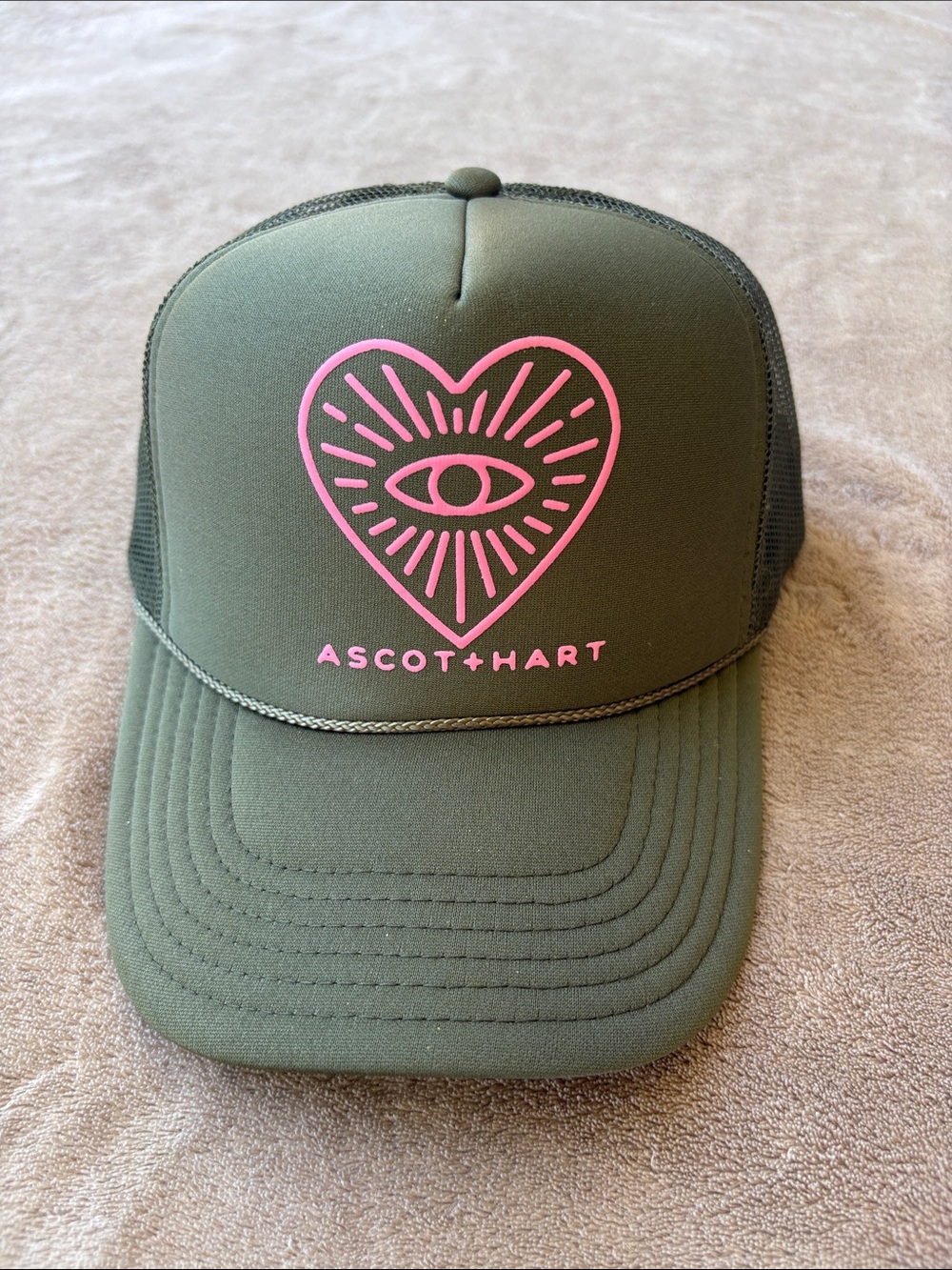 Ascot+Hart Olive Trucker Hat with Pink Heart Eye Logo